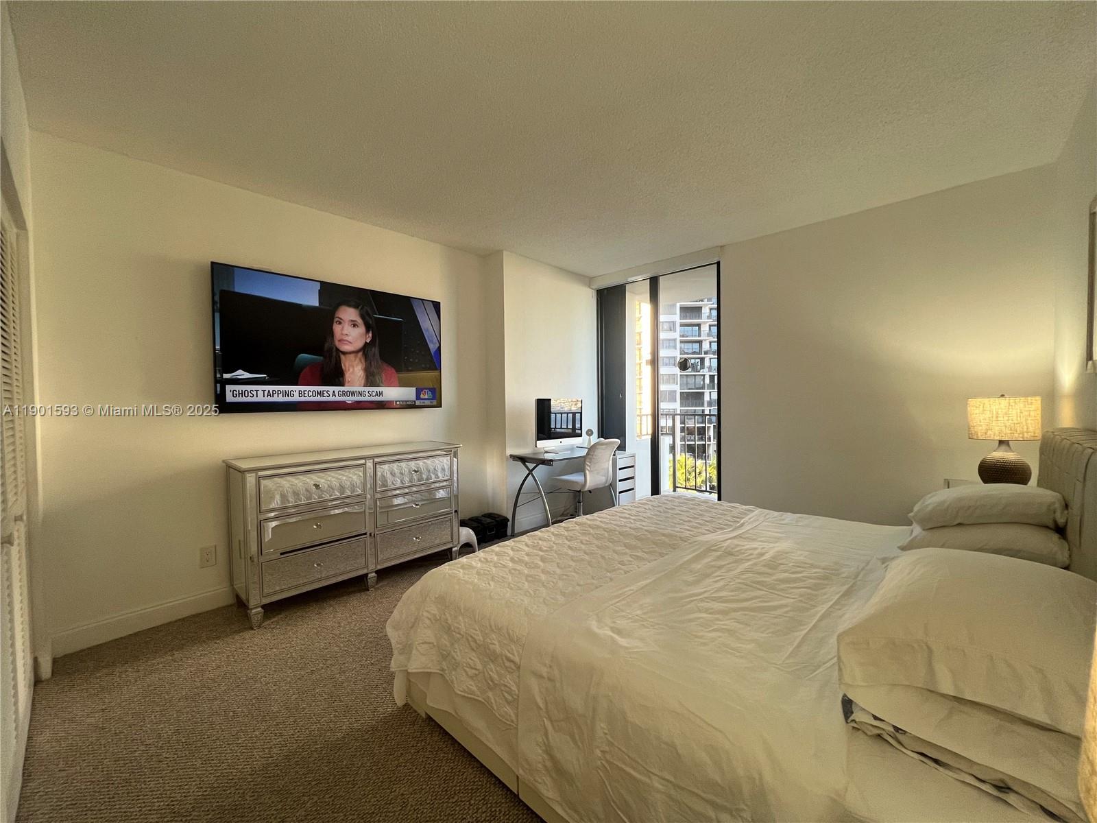 520 Brickell Key Drive, Unit A900 Miami, FL 33131 - Photo 5 of 58 a bedroom with bed and flat screen tv