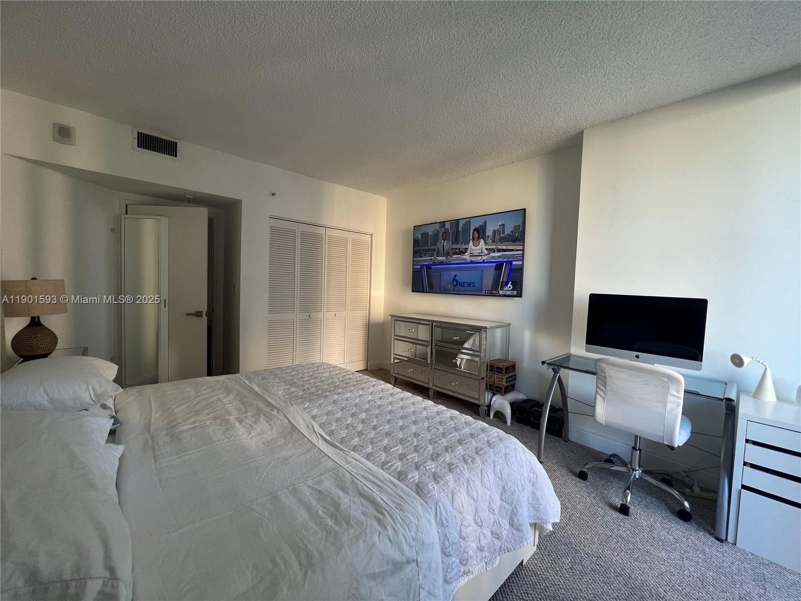 520 Brickell Key Drive, Unit A900 Miami, FL 33131 - Photo 8 of 58 a bedroom with a bed and a chair