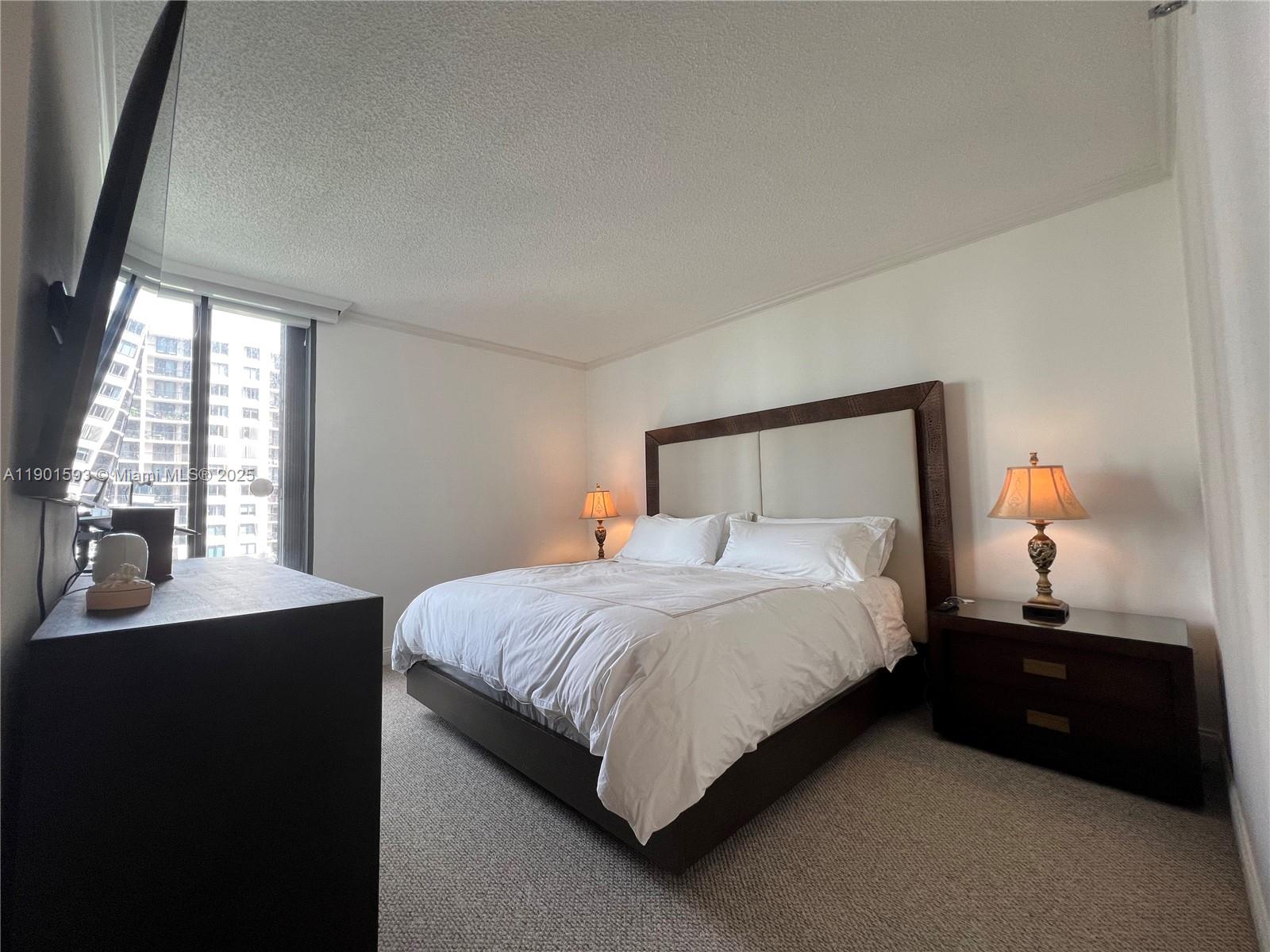520 Brickell Key Drive, Unit A900 Miami, FL 33131 - Photo 10 of 58 a bedroom with a bed and window