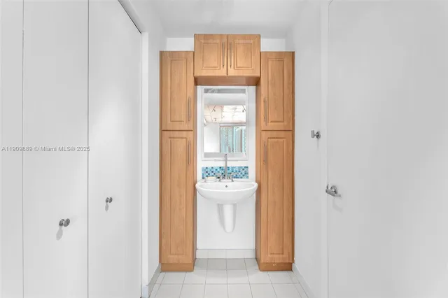a view of a bathroom with a sink and mirror