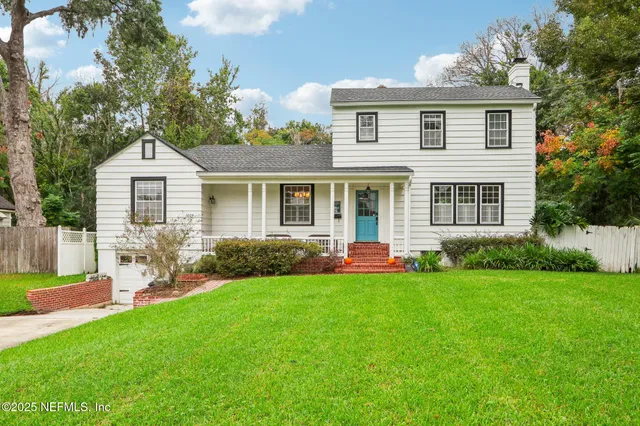 a front view of a house with a yard table and chairs