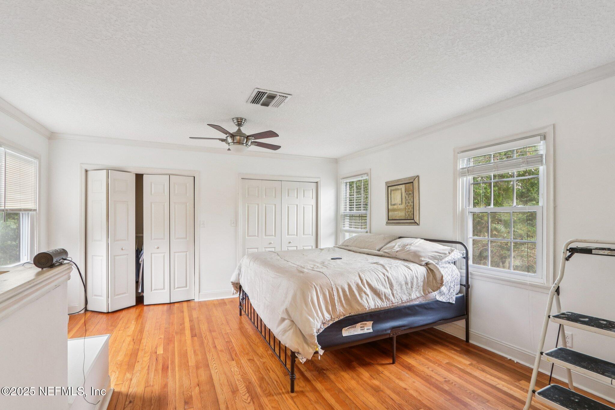 1605 Lorimier Road Jacksonville, FL 32207 - Photo 37 of 57 a bedroom with a bed and wooden floor