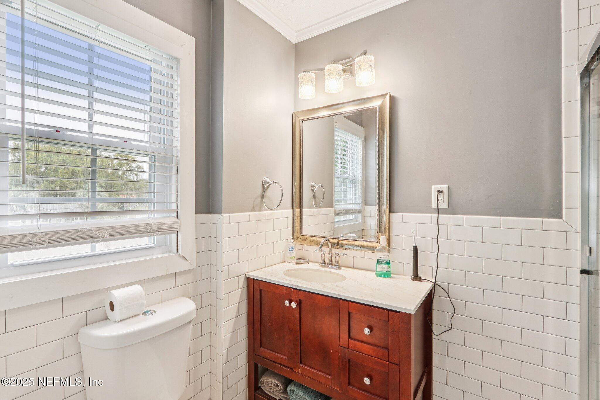 1605 Lorimier Road Jacksonville, FL 32207 - Photo 40 of 57 a bathroom with a sink a toilet and mirror