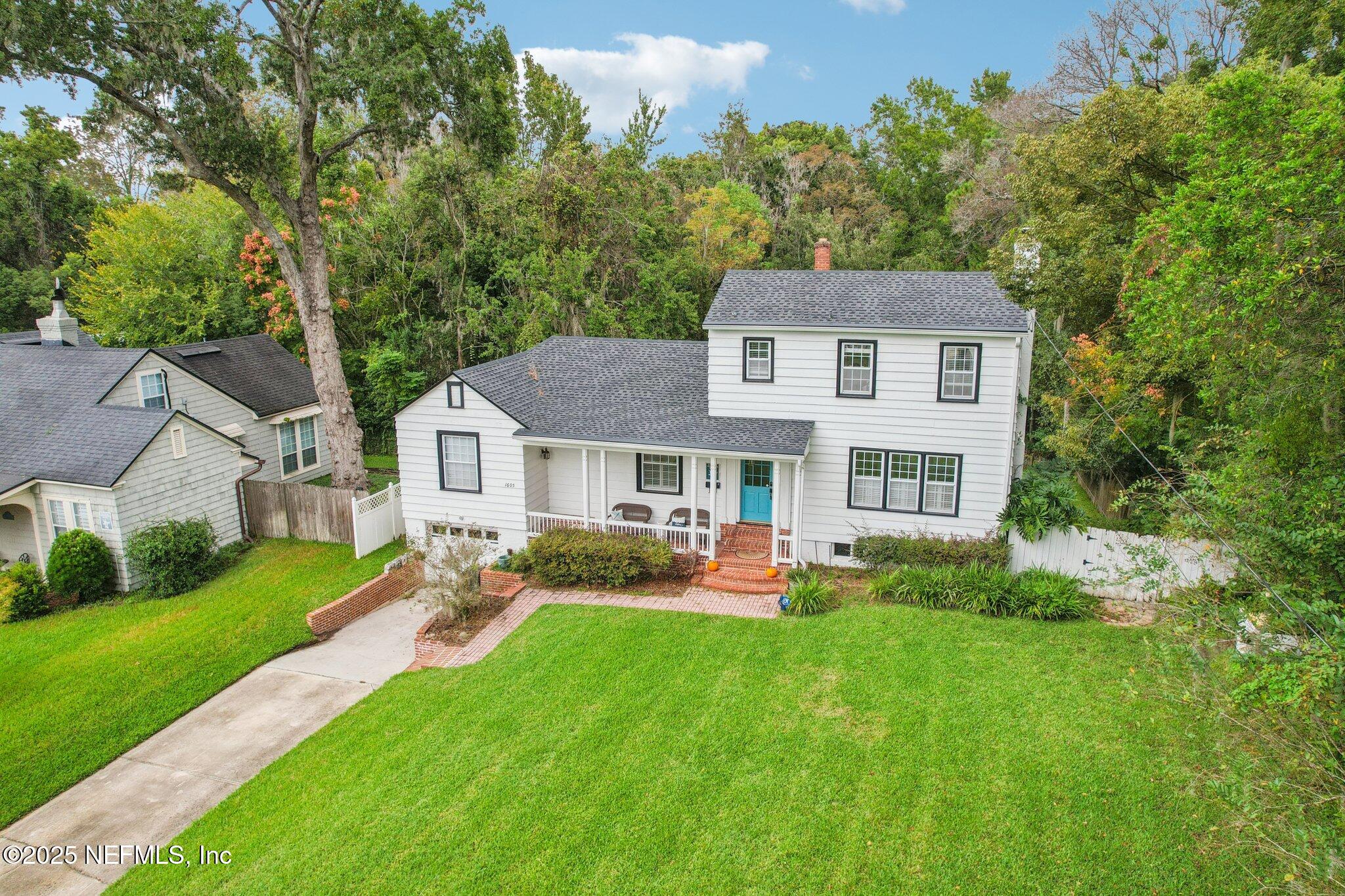 1605 Lorimier Road Jacksonville, FL 32207 - Photo 8 of 57 a front view of a house with a garden and trees