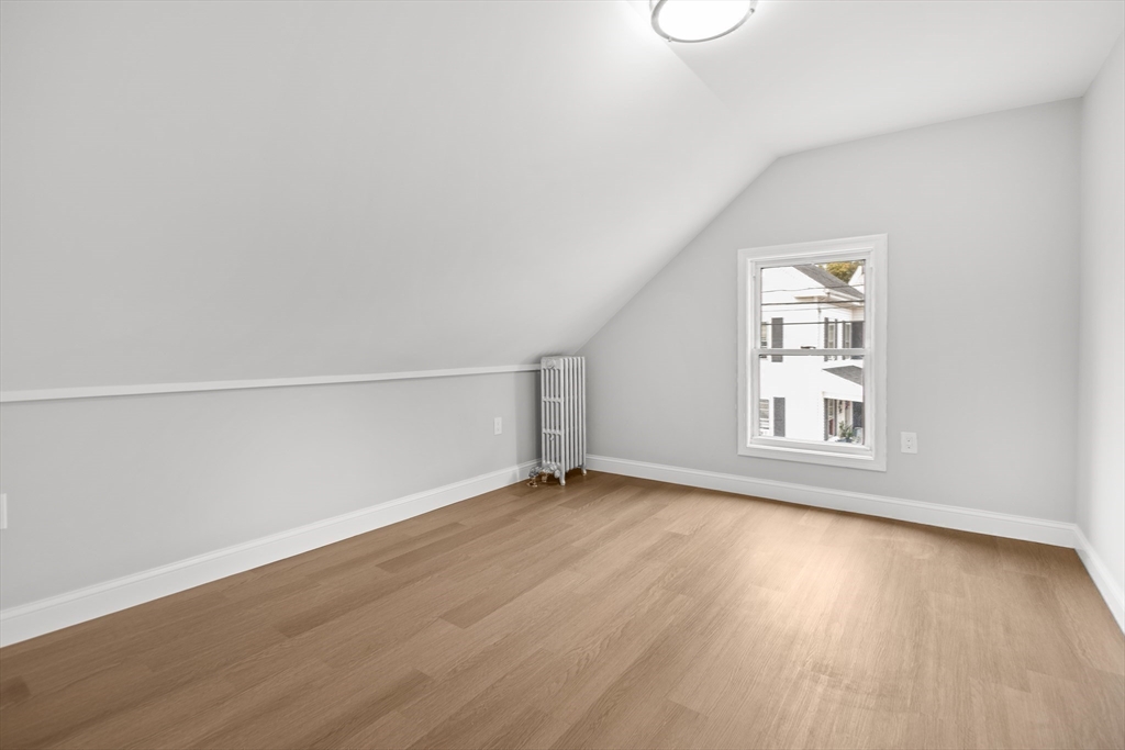 57 Ord Street Salem, MA 01970 - Photo 16 of 40 an empty room with wooden floor and windows