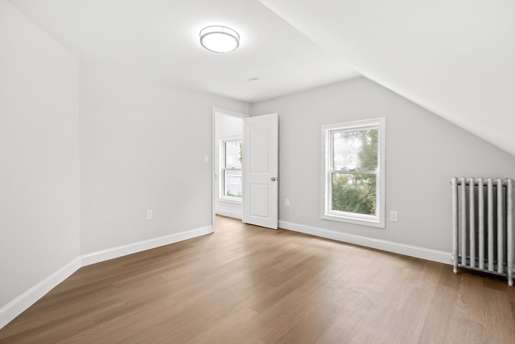 57 Ord Street Salem, MA 01970 - Photo 17 of 40 an empty room with wooden floor and windows