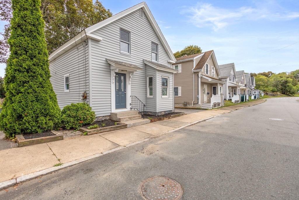57 Ord Street Salem, MA 01970 - Photo 2 of 40 a front view of a house with a yard and garage