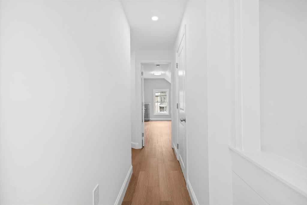 57 Ord Street Salem, MA 01970 - Photo 23 of 40 a view of a hallway with wooden floor and a bathroom