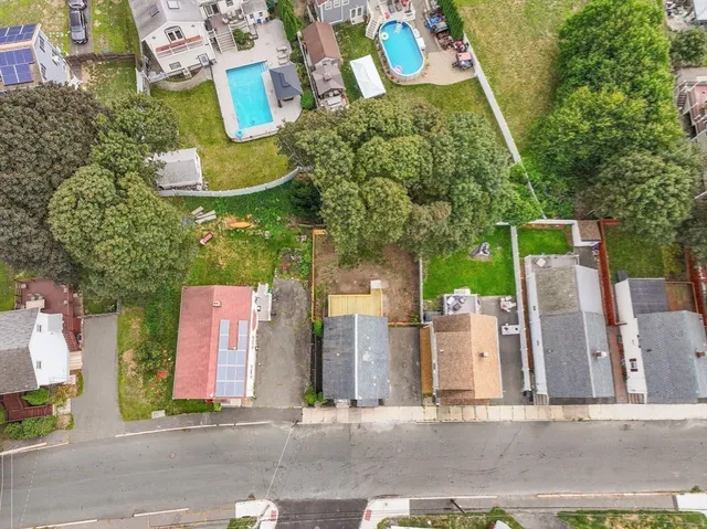 an aerial view of residential house with outdoor space and parking