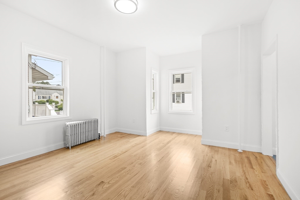 57 Ord Street Salem, MA 01970 - Photo 10 of 40 an empty room with wooden floor and windows