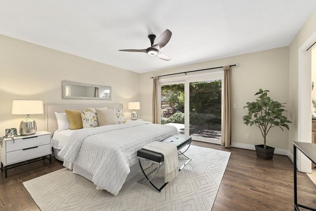 a bedroom with a large bed and a potted plant