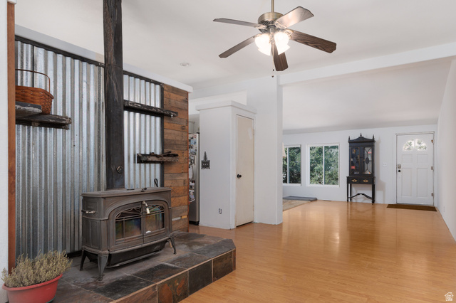 3902 Beaver Creek Road Kamas, UT 84036 - Photo 11 of 33 Living area featuring ight wood-style floors, ceiling fan, and a wood stove