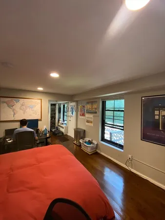 a bedroom with a large bed and a large window