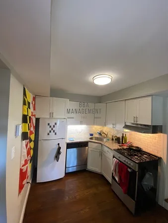 a kitchen with stainless steel appliances granite countertop a stove and a refrigerator