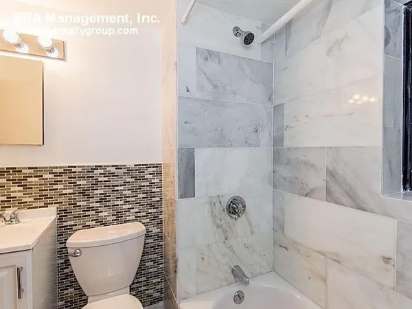 a bathroom with a toilet and a shower