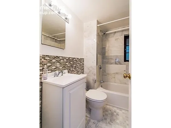 a bathroom with a toilet a sink and a mirror
