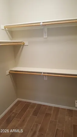 an empty room with wooden floor and closet