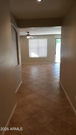 an empty room with windows and cabinet