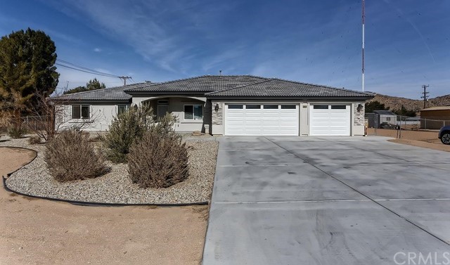 20016 Seneca Road Apple Valley, CA 92307 - Photo 1 of 1 a view of a house with a small yard and plants