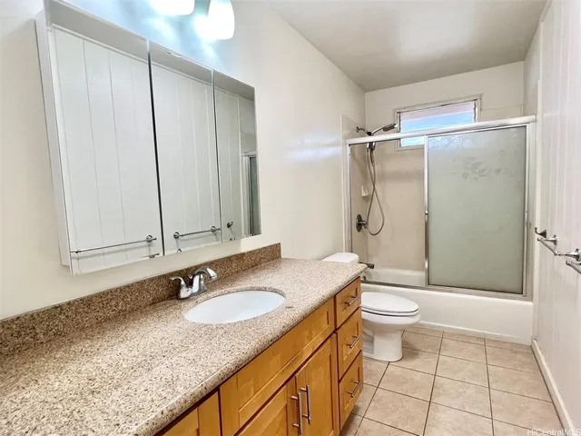 a view of a small house with wooden fence