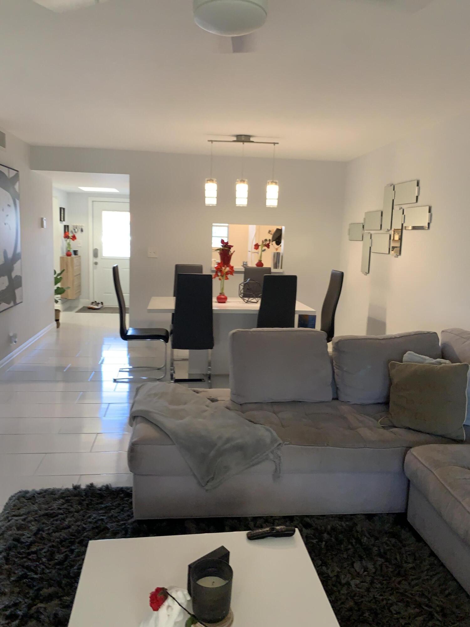 2500 Fiore Way, Unit 109 Delray Beach, FL 33445 - Photo 12 of 16 a living room with furniture and a couch