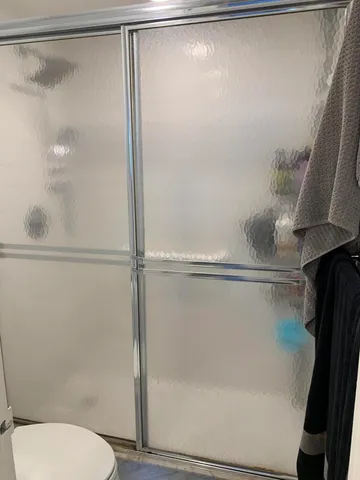 a bathroom with a shower and a toilet