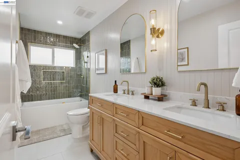 a spacious bathroom with a double vanity sink and a mirror