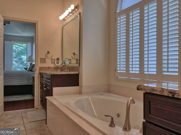 a en suite bathroom with a bathtub and a sink
