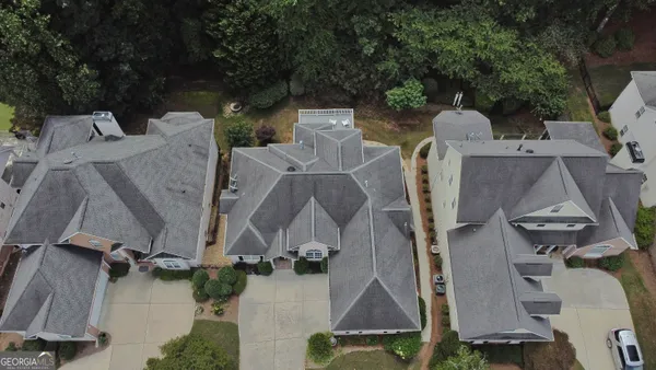 an aerial view of a house with outdoor space and a lake view