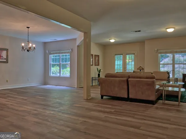 a living room with furniture and a chandelier