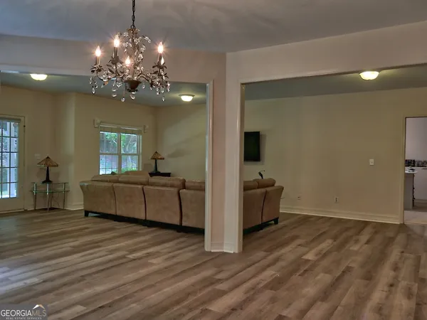 a living room with furniture and a chandelier