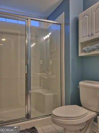 a white toilet sitting next to a bathroom sink