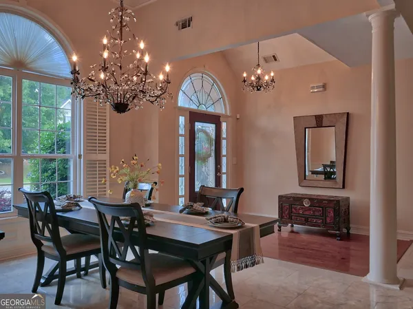 a view of a dining room with furniture wooden floor and chandelier