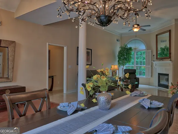 a living room with furniture chandelier and a fireplace