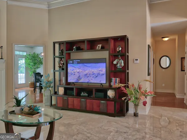 a living room with furniture and potted plants