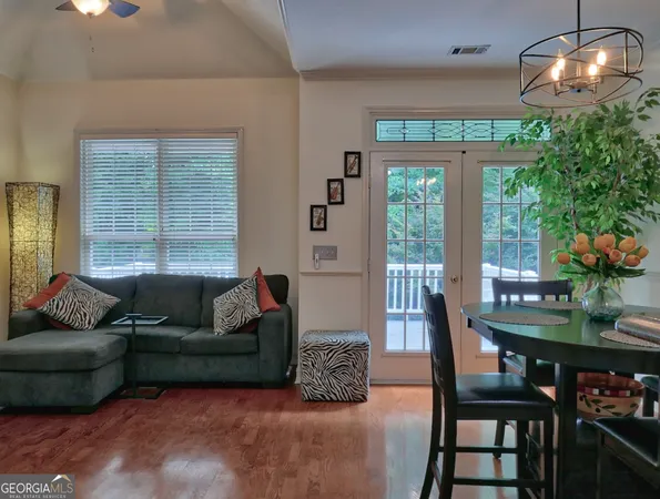 a living room with furniture and a chandelier