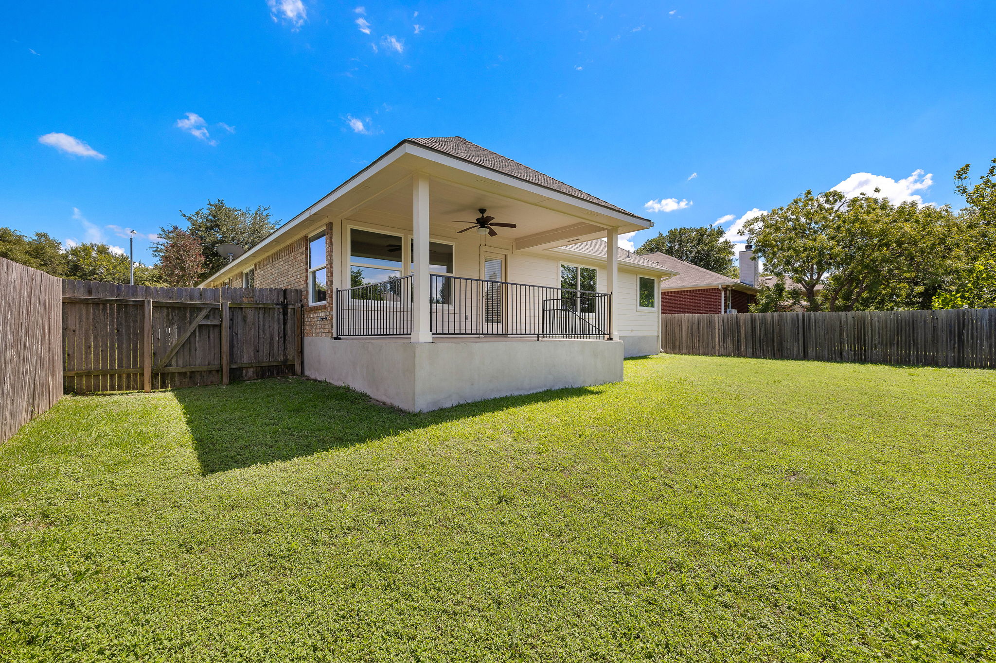 1100 Springbrook Road Pflugerville, TX 78660 - Photo 20 of 23 A generous backyard offers a private covered patio, ideal for outdoor entertaining.