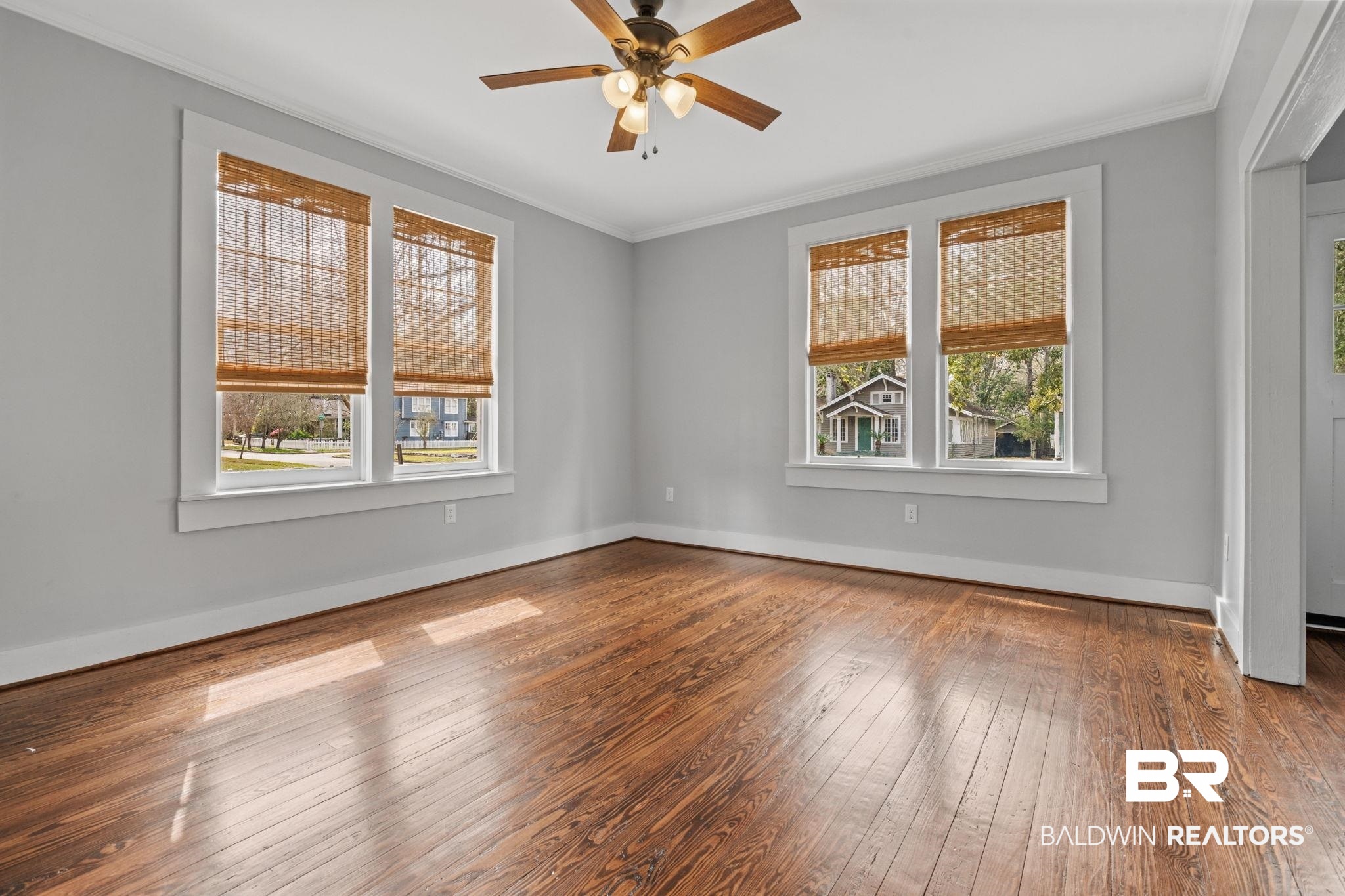 123 Macy Place Mobile, AL 36604 - Photo 7 of 35 Empty room featuring dark wood-type flooring, a ceiling fan, and ornamental molding