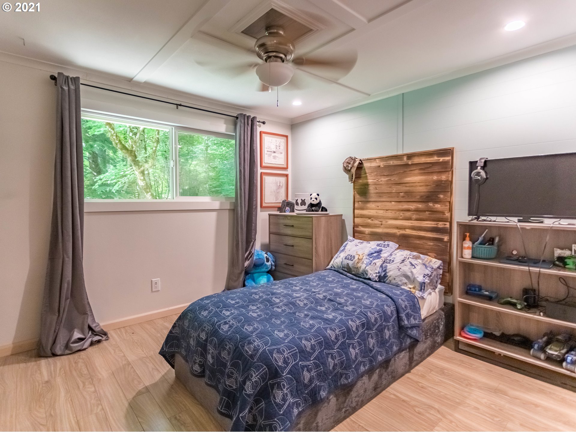 43900 Southeast Keisecker Road Sandy, OR 97055 - Photo 14 of 31 a bedroom with a large bed and a flat tv screen