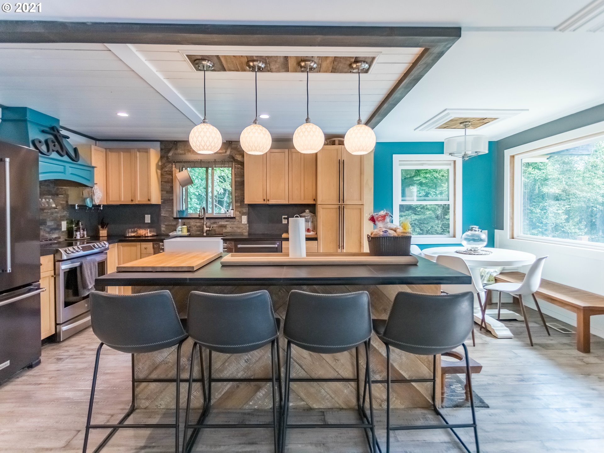 43900 Southeast Keisecker Road Sandy, OR 97055 - Photo 6 of 31 a kitchen with a dining table chairs sink and wooden floor