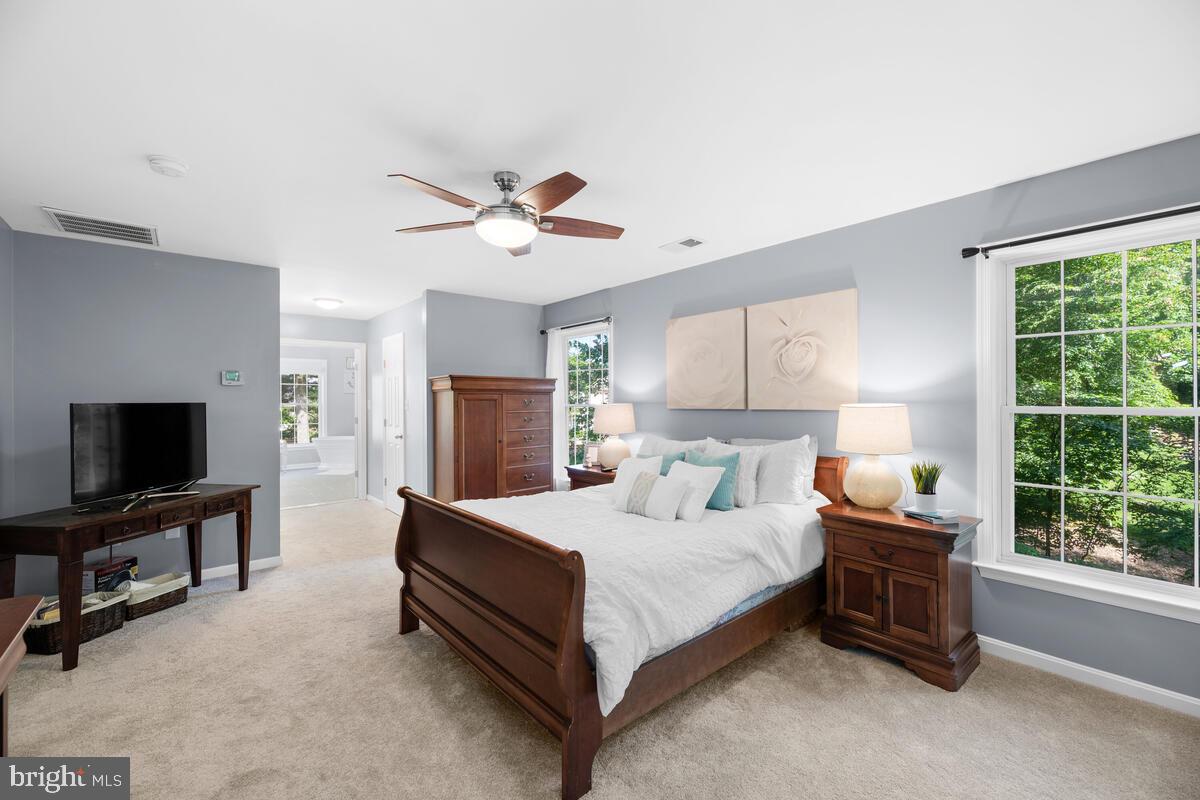 2395 Sunset Farm Road Ellicott City, MD 21042 - Photo 28 of 73 a bedroom with a bed a window and a flat screen television