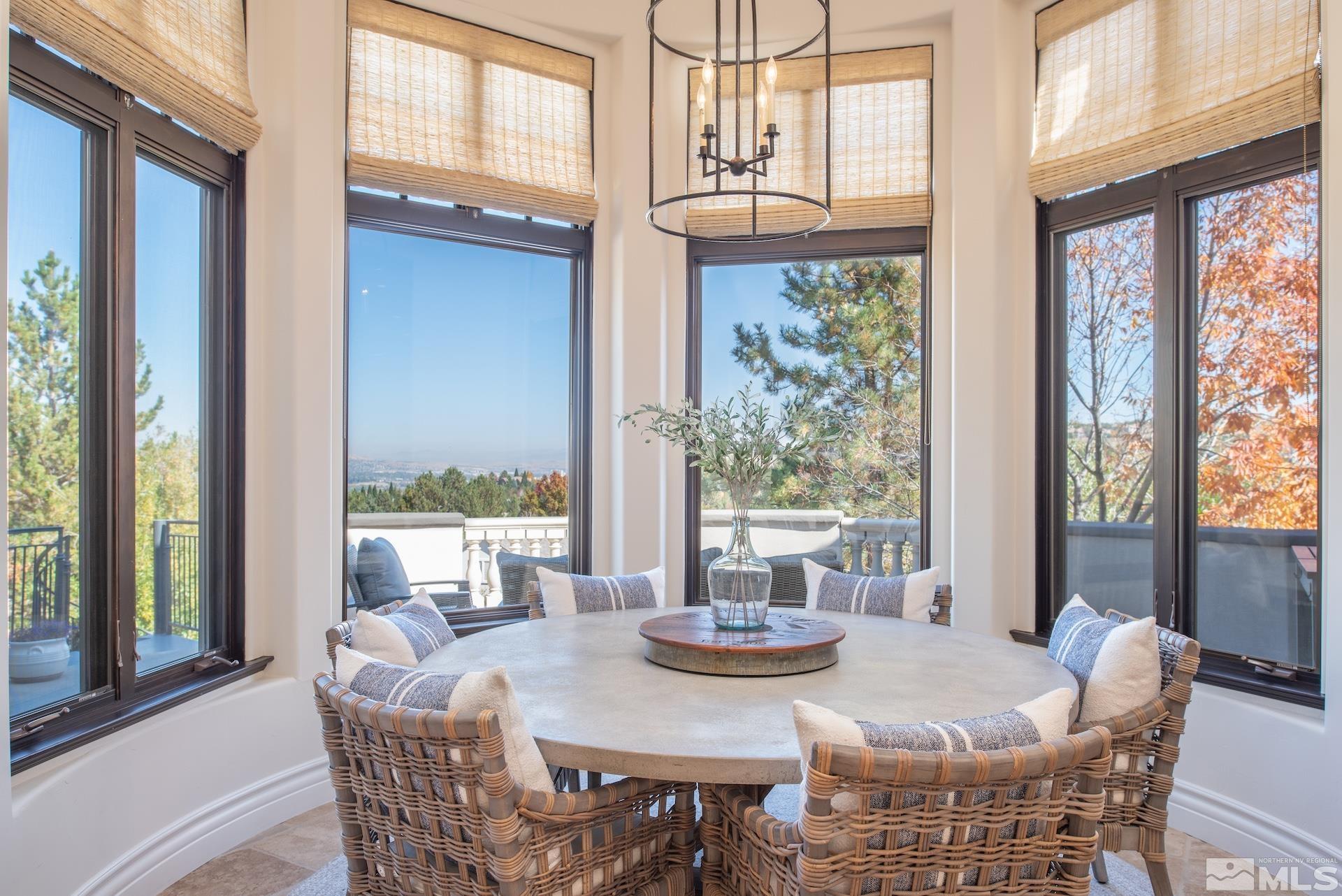 175 Hawken Road Reno, NV 89519 - Photo 13 of 40 a view of a dining room with furniture large windows and wooden floor