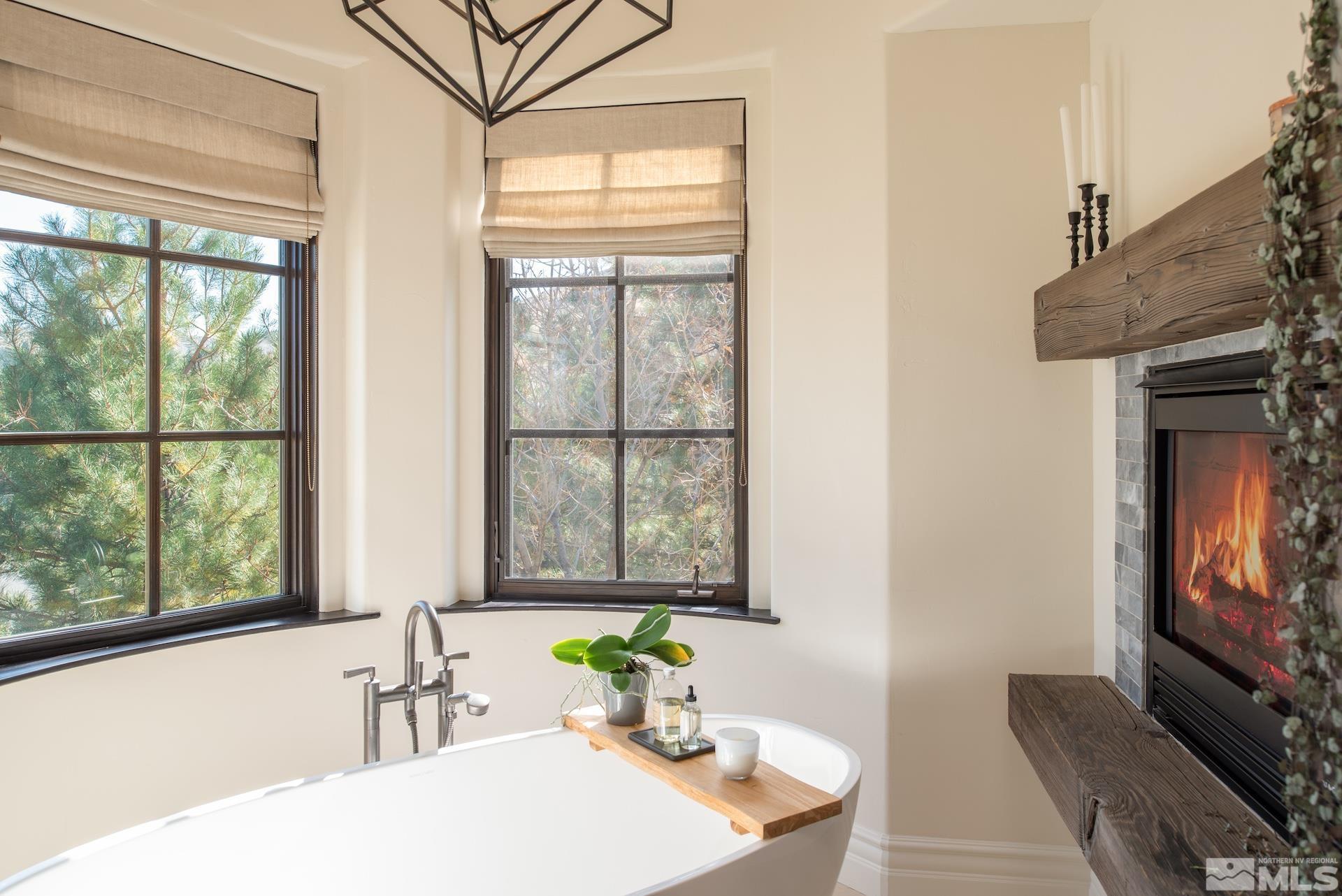 175 Hawken Road Reno, NV 89519 - Photo 22 of 40 a bathroom with a sink a large window and a flat screen tv