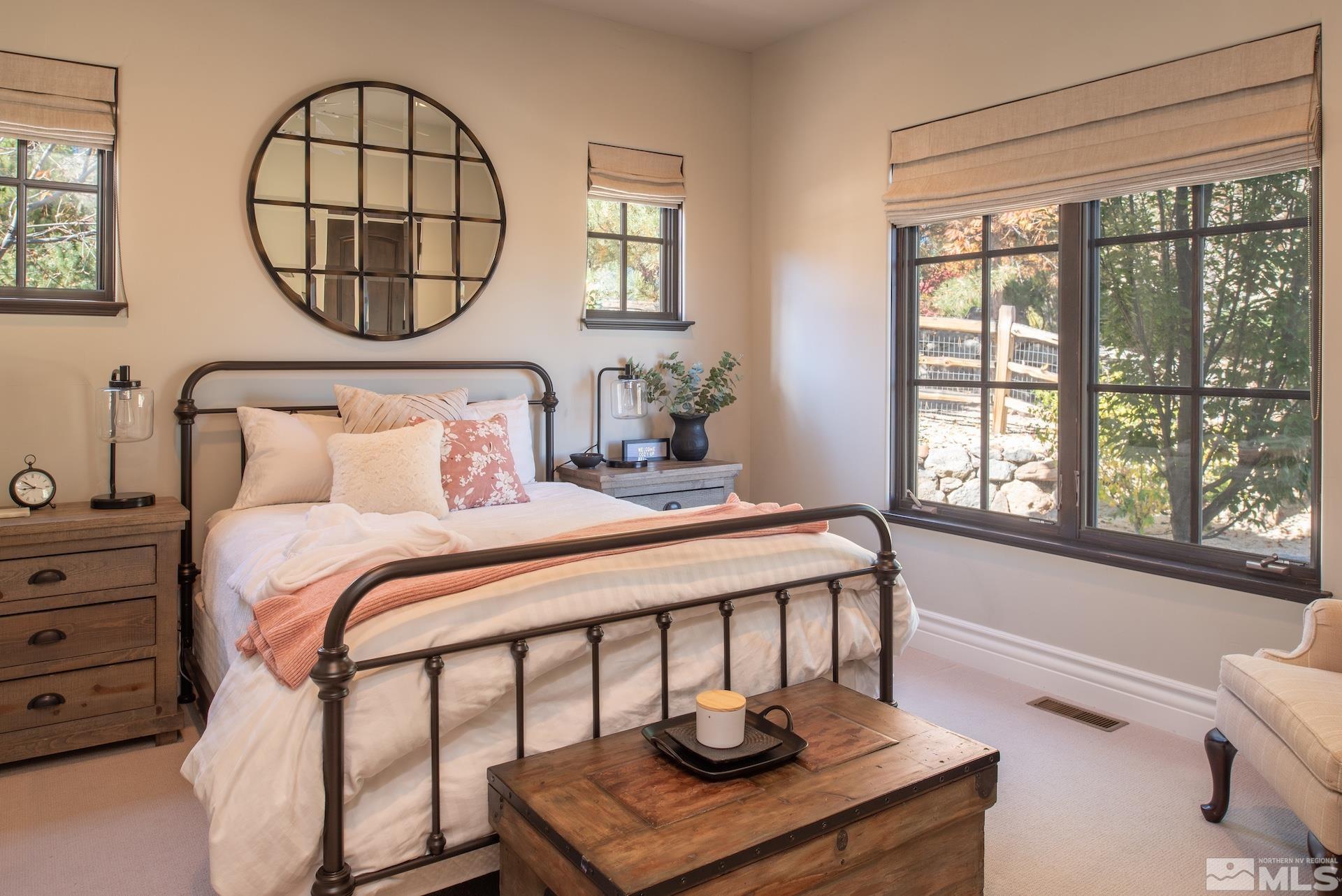 175 Hawken Road Reno, NV 89519 - Photo 26 of 40 a bedroom with a bed a mirror and a window