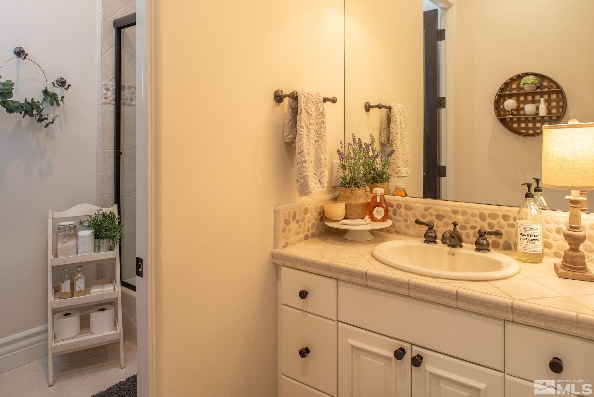 175 Hawken Road Reno, NV 89519 - Photo 27 of 40 a bathroom with a sink and a mirror