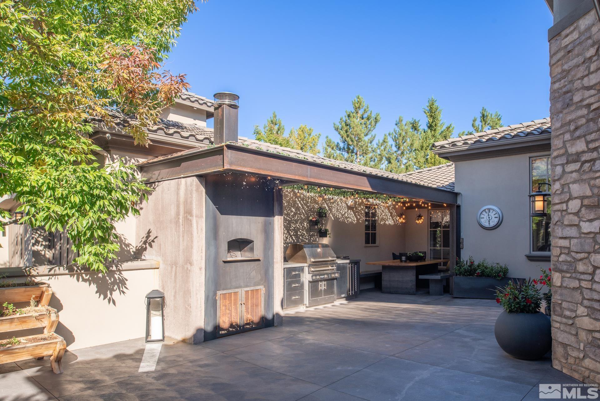 175 Hawken Road Reno, NV 89519 - Photo 3 of 40 a view of a patio with table and chairs potted plants with wooden fence