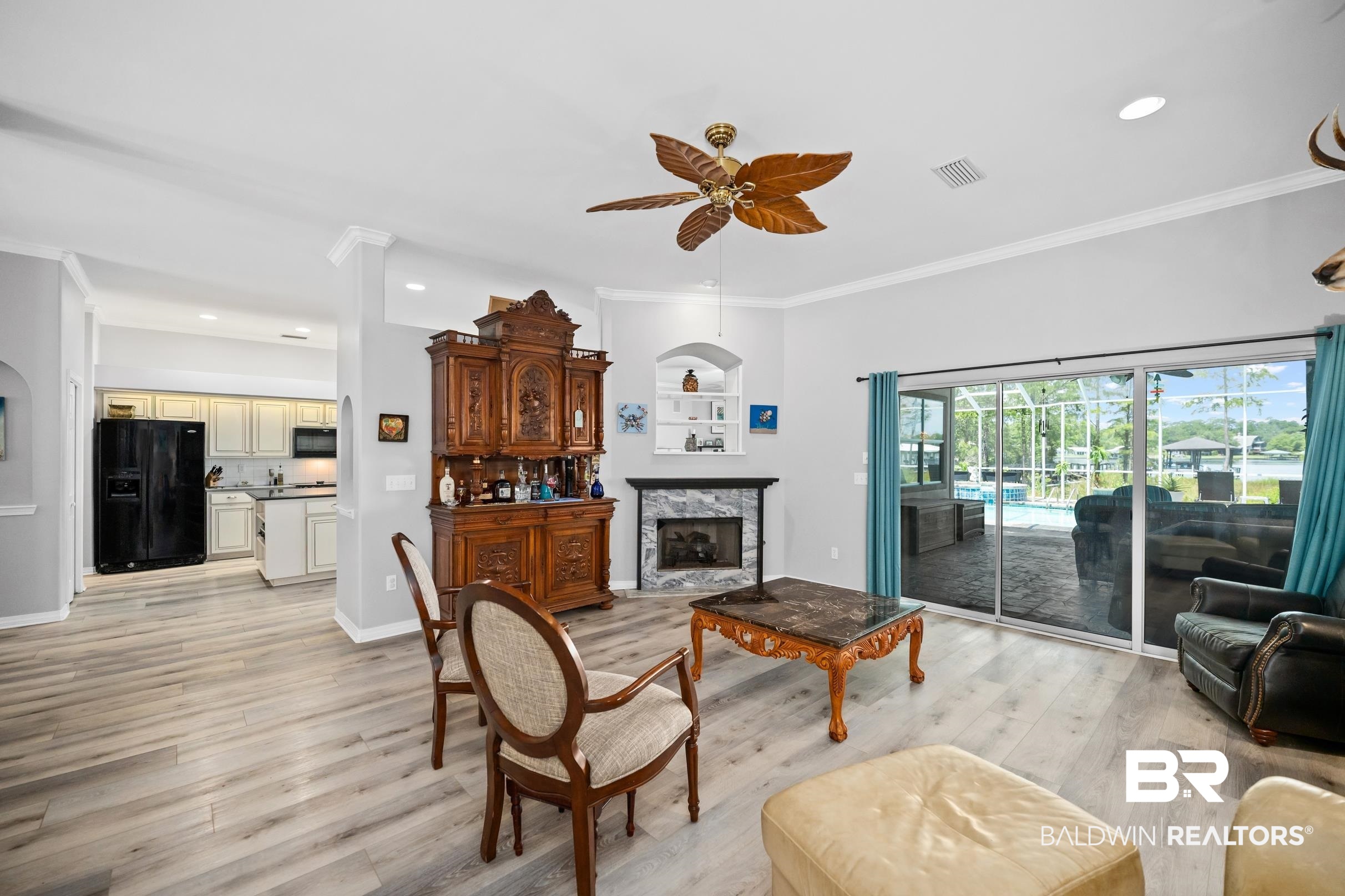 8585 Bay Harbor Road Elberta, AL 36530 - Photo 16 of 51 Living area with ceiling fan, light wood finished floors, recessed lighting, a high end fireplace, and crown molding