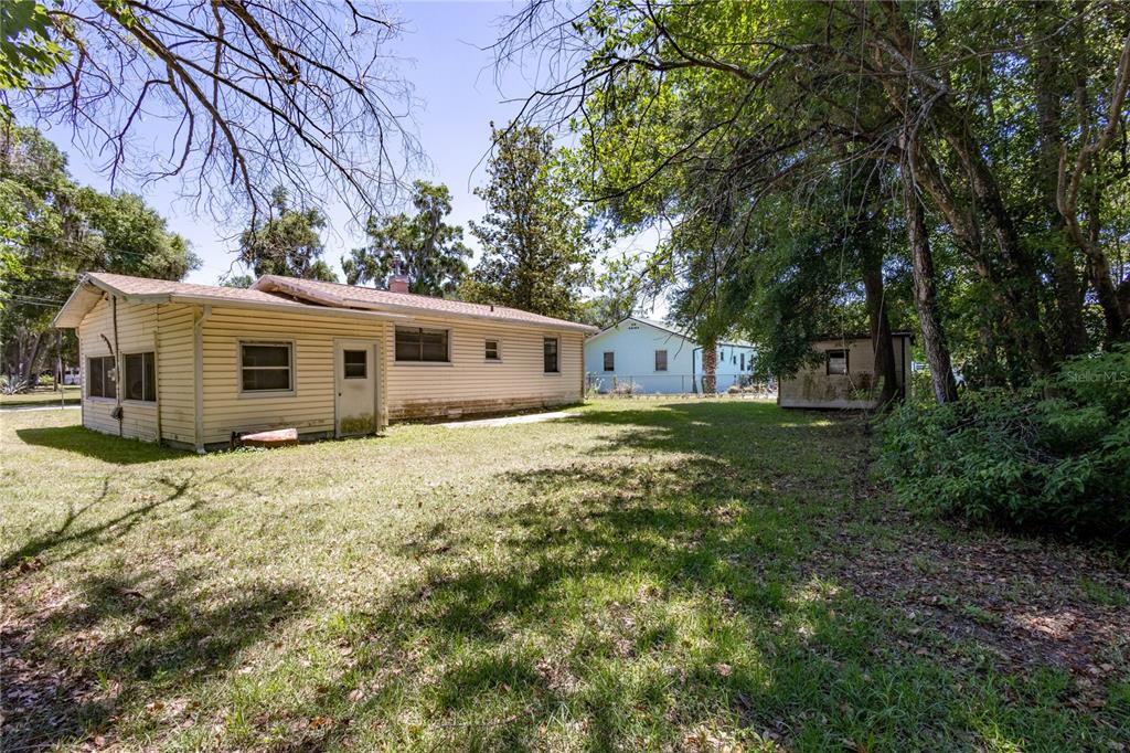 6281 Southeast Hames Road Belleview, FL 34420 - Photo 13 of 16 a view of a house with a backyard