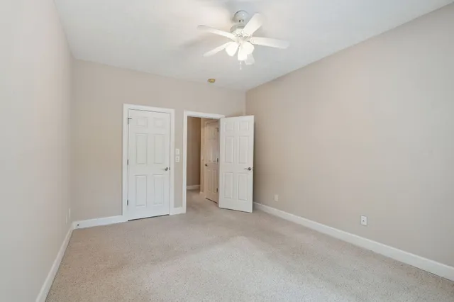 a bathroom with a sink a toilet a mirror and shower