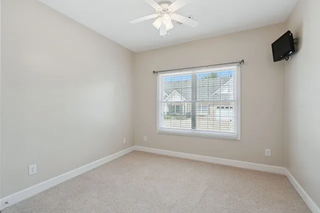 an empty room with a ceiling fan